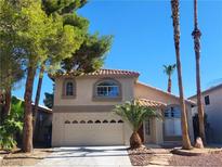 Charming two-story home featuring a well-manicured front yard, two car garage and desert landscaping at 8712 Texas Bronco Ave, Las Vegas, NV 89129