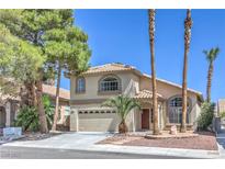 Charming two-story home featuring a well-manicured front yard and attached two-car garage at 8712 Texas Bronco Ave, Las Vegas, NV 89129