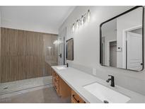 Modern bathroom featuring a double vanity, sleek fixtures, and a stylish tiled shower at 913 Duckhorn Ct # 201, Las Vegas, NV 89144