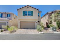 Charming two-story home with an attached two-car garage and well-manicured front yard at 9217 Valley Betica Ave, Las Vegas, NV 89148