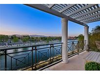 Enjoy water views from this beautiful balcony with a pergola and railing at 9430 Laguna Niguel Dr # 203, Las Vegas, NV 89134