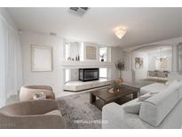 Bright living room showcases modern fireplace, neutral tones, and elegant decor for a cozy and stylish space at 9604 Summer Cypress St, Las Vegas, NV 89123