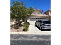 Charming single-Gathering home featuring a two-car garage and well-maintained front yard, perfect for suburban living at 9940 Trailing Vine St, Las Vegas, NV 89183