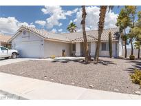 Charming single-story home with desert landscaping, tiled roof, and a two-car garage at 998 Hunters Run Dr, Henderson, NV 89002
