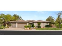 Stunning single-story home with mature landscaping and a three-car garage, showcasing elegant design at 1 Dry Brook Trl, Henderson, NV 89052