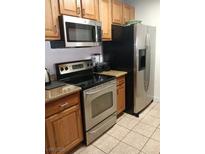 Kitchen features stainless steel appliances including microwave, oven, and refrigerator at 1515 E Reno Ave # D202, Las Vegas, NV 89119