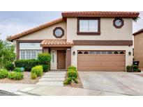 Charming two-story home featuring a well-manicured lawn and a two-car garage at 2705 Chokecherry Ave, Henderson, NV 89074