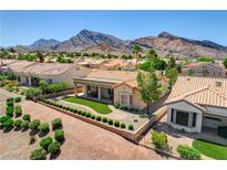 Beautiful single story home with manicured lawn and landscaping against mountain backdrop at 3120 Darby Falls Dr, Las Vegas, NV 89134