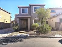 Charming two-story home featuring a covered porch, well-maintained landscaping, and a neutral color palette at 5651 Bettors Luck Ct, Las Vegas, NV 89122