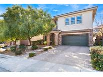 Charming two-story home featuring desert landscaping, stone accents, a brick driveway, and an attached two-car garage at 5735 Oak Bend Dr, Las Vegas, NV 89135