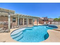 Inviting backyard pool with a covered patio and a tranquil spa area, perfect for relaxation at 5889 Wildhorse Ledge Ave, Las Vegas, NV 89131