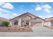 Charming single-story home featuring a neutral color palette and a well-maintained front yard at 632 Hitchen Post Dr, Henderson, NV 89011