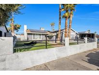 Charming single-story home with white exterior walls, solar panels and xeriscaped front yard at 7026 Westpark Ct, Las Vegas, NV 89147