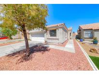 Charming single-story home featuring a two-car garage, low-maintenance landscaping, and a inviting walkway at 7212 Nordic Lights Dr, Las Vegas, NV 89119