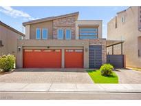 Modern two-story home with brick driveway, a two-car garage and stone accents at 8955 Ruby Moon Dr, Las Vegas, NV 89139