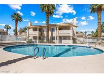 Exterior view of a community pool surrounded by palm trees, perfect for relaxation and outdoor enjoyment at 1001 Sulphur Springs Ln # 202, Las Vegas, NV 89128