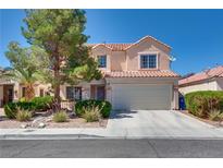 Charming two-story home with a well-maintained front yard and attached two-car garage in a residential neighborhood at 1048 Menands Ave, Las Vegas, NV 89123
