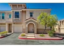 Charming townhome with a private garage, cozy entrance, and desert landscaping at 10550 W Alexander Rd # 2220, Las Vegas, NV 89129