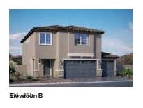 Two-story home featuring a three car garage and desert landscaping at 1198 Dre Harbor Pl. Ln # 86, North Las Vegas, NV 89084