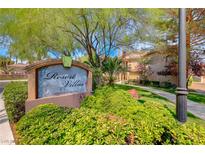 Community entrance sign surrounded by lush landscaping at the Resort Villas at 2050 W Warm Springs Rd # 4021, Henderson, NV 89014