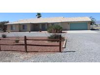 Charming single-story home with a gravel yard and a two car garage at 2201 E Dandelion St, Pahrump, NV 89048