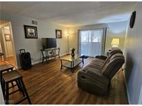 Cozy living room featuring hardwood floors, a plush sofa, and abundant natural light at 2451 N Rainbow Blvd # 1123, Las Vegas, NV 89108