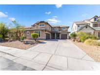 Beautiful two-story home featuring a three-car garage and desert landscaping at 2625 Cattrack Ave, North Las Vegas, NV 89081