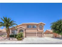 Charming two-story home with a three-car garage, desert landscaping, and a mature palm tree at 2728 Aspen Wood Ave, Henderson, NV 89074