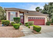 Charming single-story home with well-maintained landscaping, a tiled roof, and a two-car garage at 3200 Ridgecliff St, Las Vegas, NV 89129