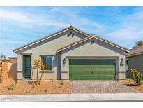 Charming single-story home featuring a quaint front yard and a two-car garage at 4404 Cave Lake Ave, North Las Vegas, NV 89032