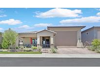 Charming single-story home with manicured lawn, covered porch, and desert landscaping at 444 Middlestone Ave, Henderson, NV 89011