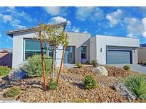 Contemporary home featuring desert landscaping, a two-car garage, and modern architectural design at 4717 S Maddington Ct, Pahrump, NV 89061
