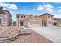Charming two-story home with a red rock landscaped yard and neutral paint at 638 Ribbon Grass Ave, Las Vegas, NV 89183
