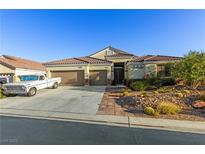 Charming single-story home with a three-car garage and well-maintained desert landscaping at 6413 White Tiger Ct, Las Vegas, NV 89130