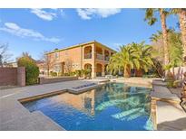 Inviting backyard pool with lush landscaping and a spacious patio, ideal for outdoor entertaining at 7258 Sashaying Spirit Ct, Las Vegas, NV 89131