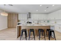 Modern kitchen with stainless steel appliances, center island and breakfast bar seating at 9632 Cherry Canyon Ave, Las Vegas, NV 89129