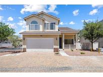 Charming two-story home featuring a two-car garage, desert landscaping, and lovely architectural details at 10348 Cherry Brook St, Las Vegas, NV 89183