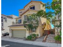 Charming two-story home boasts a two-car garage and a quaint second-story balcony at 10725 Wrigley Field Ave, Las Vegas, NV 89166