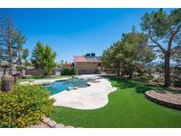Resort-like pool featuring an elegant shape, artificial turf, and ample room for outdoor enjoyment and relaxation at 1106 E Athens Ave, Henderson, NV 89015
