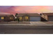 Charming single-story home featuring a two-car garage and low-maintenance desert landscaping at 2111 Hollow Oak Ave, North Las Vegas, NV 89031