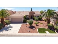 Charming single-story home with desert landscaping and palm trees on a sunny day at 2131 Waterton Rivers Dr, Henderson, NV 89044