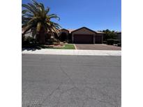 Inviting single-story home featuring a spacious three-car garage and mature landscaping at 2695 Olivia Heights Ave, Henderson, NV 89052