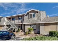 A two-story condo features gray siding, gray roof, and a metal staircase at 2785 Carnation Ln # 0, Henderson, NV 89074