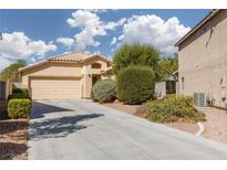 Inviting single-story home featuring a well-maintained front yard and a two-car garage at 5049 Running Rapids Ave, Las Vegas, NV 89130