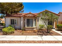 Charming single-story home with a terracotta roof, bay windows, and xeriscaped landscaping at 5424 Geneive Ln # 105, Las Vegas, NV 89108