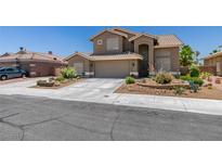 Charming two-story house featuring an attached garage, desert landscaping, and a tile roof against a clear blue sky at 6109 Sandstone Mesa Dr, Las Vegas, NV 89130