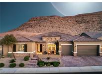 Stunning single-story home featuring a three-car garage, desert landscaping, and a beautiful mountain view at 6315 Carol Butte Ct, Las Vegas, NV 89141