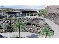 Modern home with desert landscaping, circular driveway and palms at 645 Dragon Peak Dr, Henderson, NV 89012