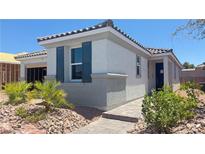 Charming single-story home with a well-manicured front yard and inviting walkway at 739 Wild Highlands Ln, Henderson, NV 89015