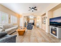 Bright living room with tile floors, fireplace, and neutral decor offers comfortable and stylish living at 7450 S Eastern Ave # 1058, Las Vegas, NV 89123
